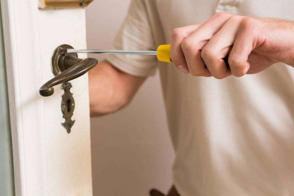 Worker putting finalizing an emergency door replacement